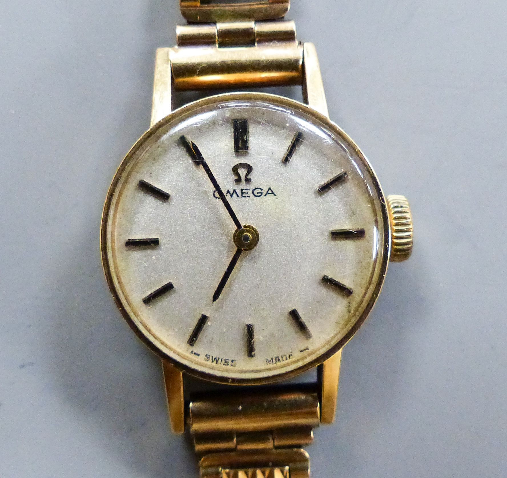 A ladys' Omega 9ct gold manual wind wristwatch, overall length 15.2cm, gross weight 15 grams, with Omega box.